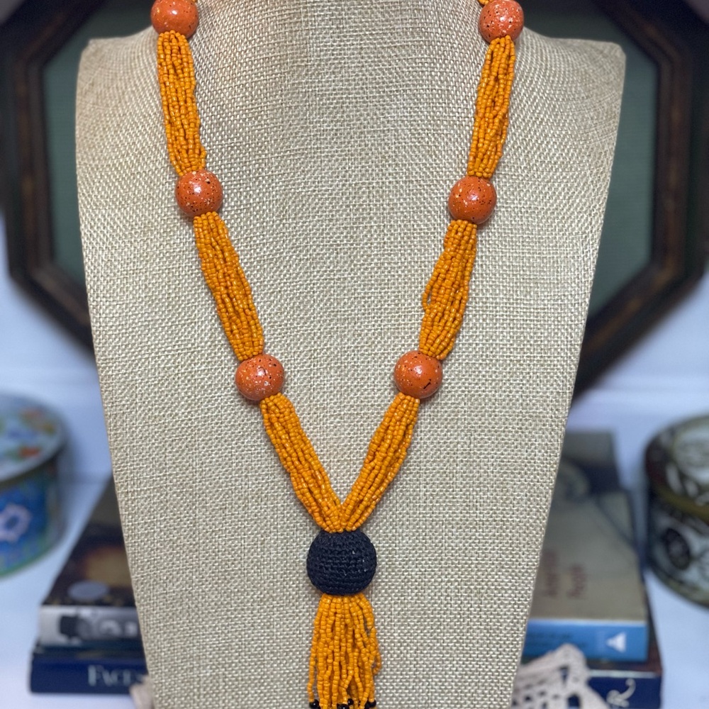 Vintage seed bead and ceramic bead necklace in orange with black accent.15” long